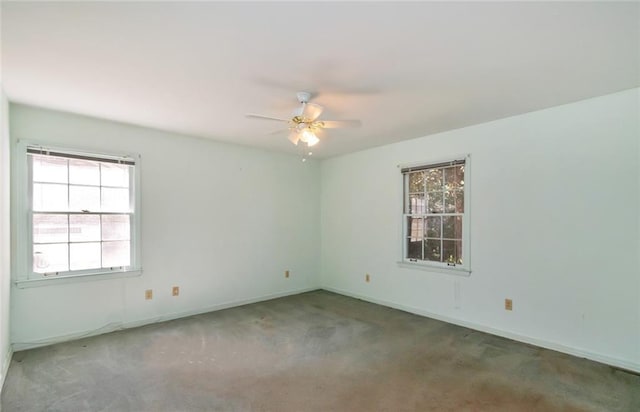 spare room featuring ceiling fan, carpet flooring, and baseboards