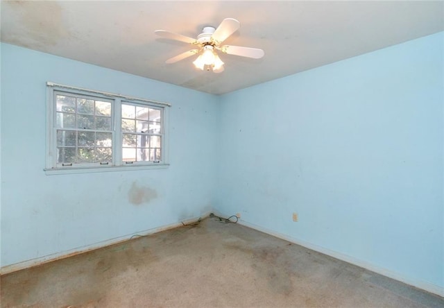 unfurnished room featuring ceiling fan, light colored carpet, and baseboards