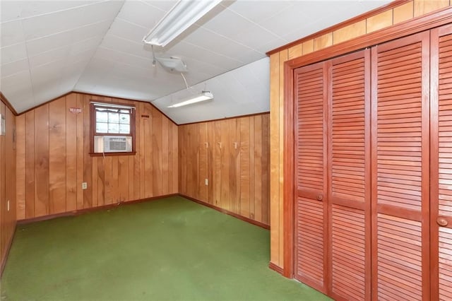 bonus room with baseboards, vaulted ceiling, cooling unit, dark colored carpet, and wood walls