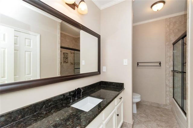 full bathroom with vanity, crown molding, bath / shower combo with glass door, toilet, and tile patterned floors