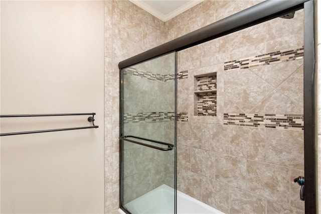 bathroom featuring ornamental molding and a shower with door