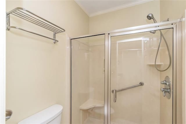 bathroom with crown molding, toilet, and an enclosed shower