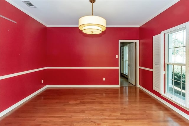 unfurnished room featuring wood-type flooring and crown molding