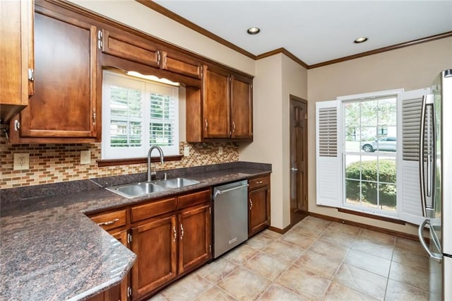 kitchen featuring light tile patterned floors, ornamental molding, sink, tasteful backsplash, and appliances with stainless steel finishes