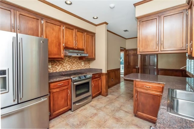 kitchen featuring appliances with stainless steel finishes, backsplash, light tile patterned floors, crown molding, and sink