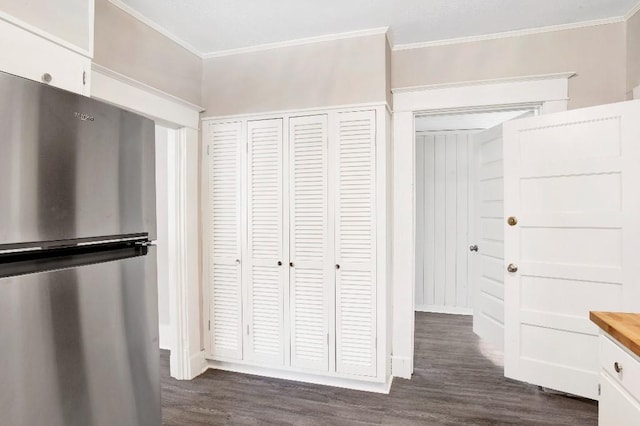 interior space featuring crown molding, stainless steel fridge, and dark hardwood / wood-style floors