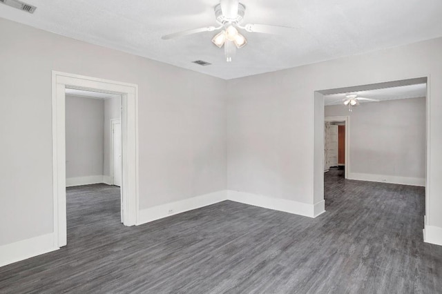 unfurnished room with dark wood-type flooring and ceiling fan