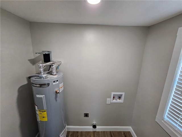 washroom featuring water heater, electric dryer hookup, hookup for a washing machine, and dark hardwood / wood-style flooring