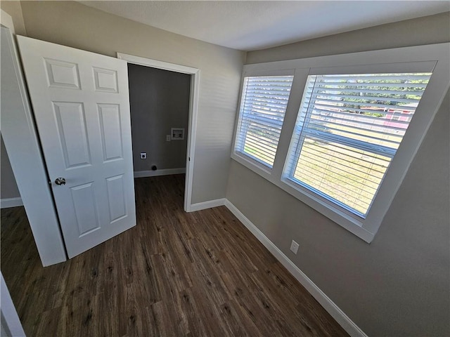 unfurnished bedroom with dark hardwood / wood-style floors