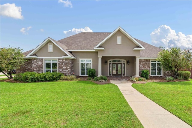view of front of property with roof with shingles, stucco siding, french doors, and a front yard