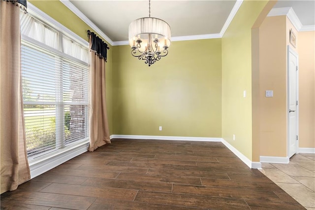 unfurnished dining area with an inviting chandelier, baseboards, crown molding, and wood finished floors