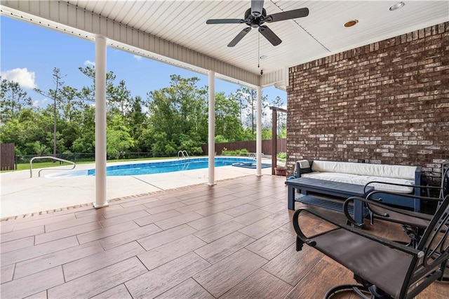 view of swimming pool with a patio, ceiling fan, a fenced in pool, and a fenced backyard