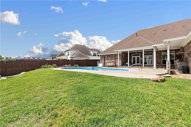 view of yard featuring a fenced in pool, french doors, a fenced backyard, and a patio area