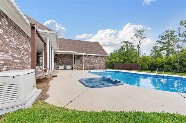 view of pool with a fenced backyard, a patio area, and a pool with connected hot tub