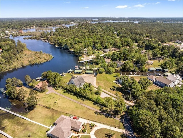 birds eye view of property with a residential view, a view of trees, and a water view