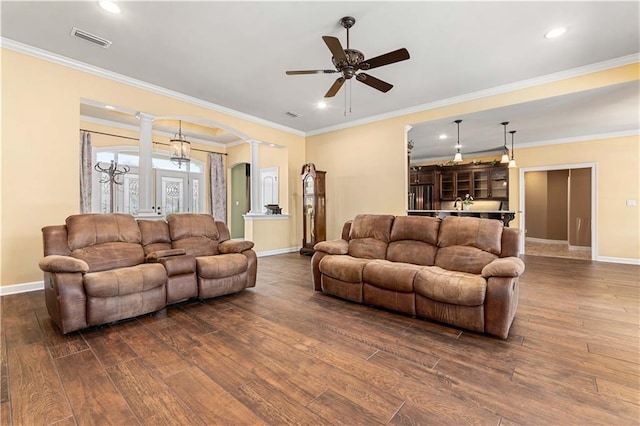 living room with decorative columns, baseboards, visible vents, and dark wood finished floors
