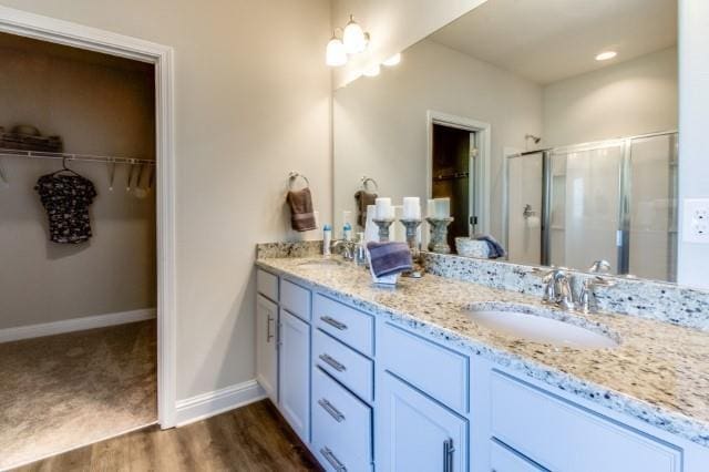 bathroom with vanity, hardwood / wood-style floors, and walk in shower