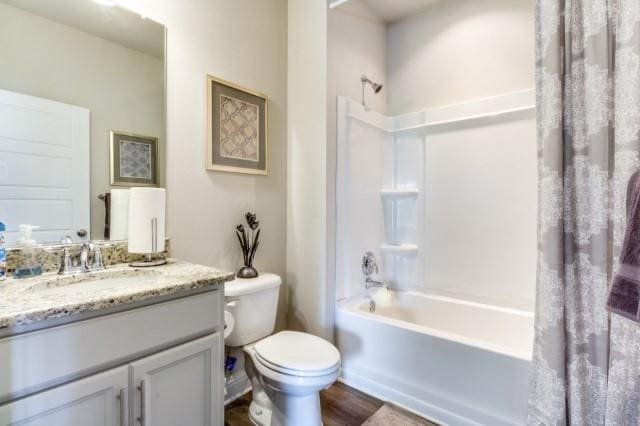 full bathroom featuring shower / bath combination with curtain, vanity, toilet, and hardwood / wood-style flooring