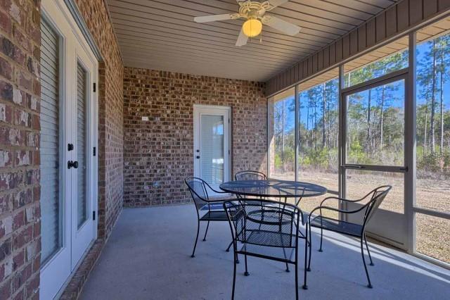 sunroom / solarium featuring ceiling fan