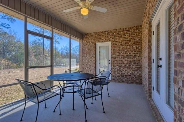 sunroom / solarium featuring ceiling fan