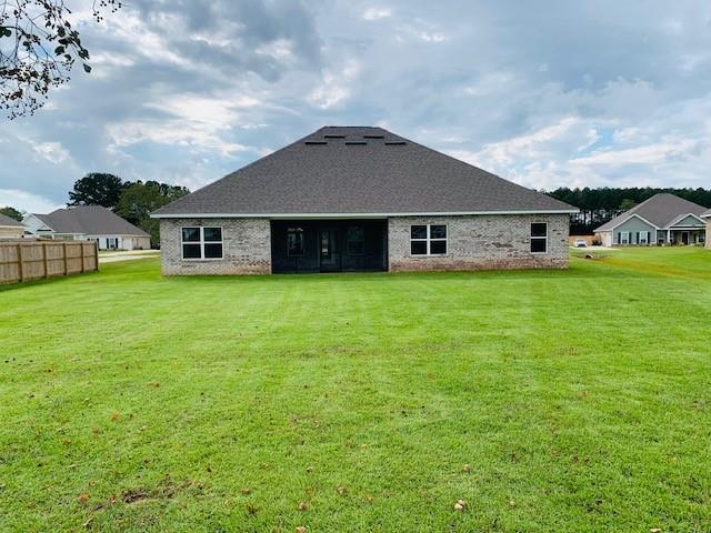 back of house featuring a yard