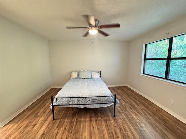 bedroom with ceiling fan and hardwood / wood-style floors