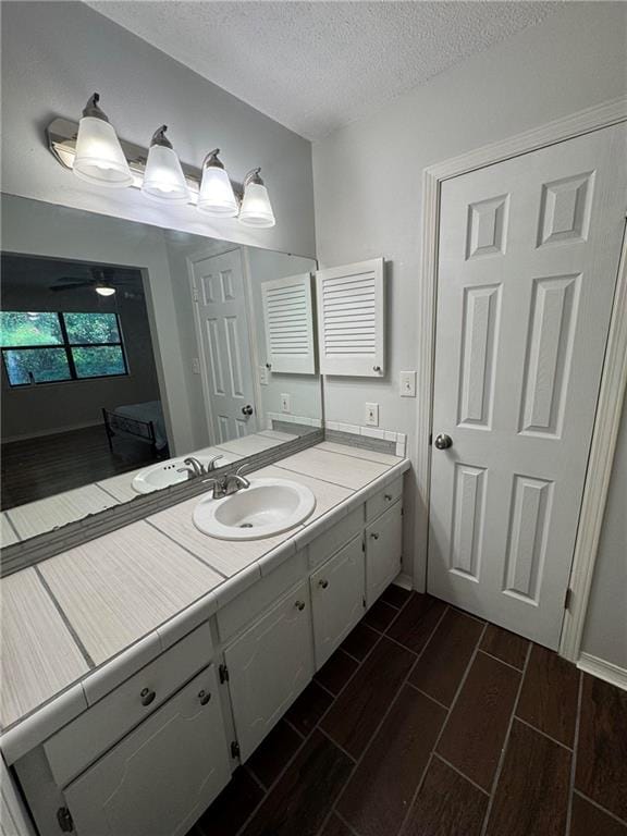 bathroom with vanity and a textured ceiling