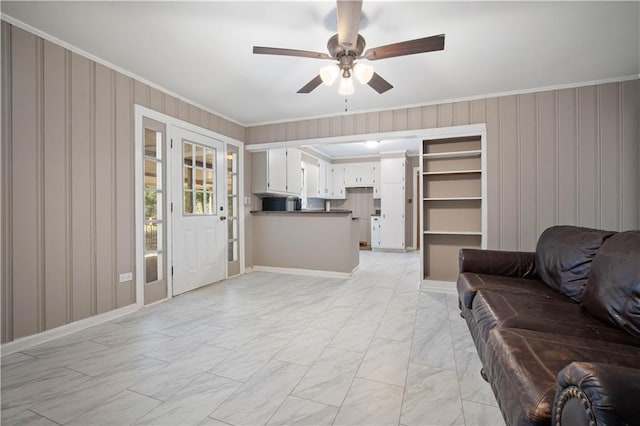 living room with ornamental molding, marble finish floor, and a ceiling fan