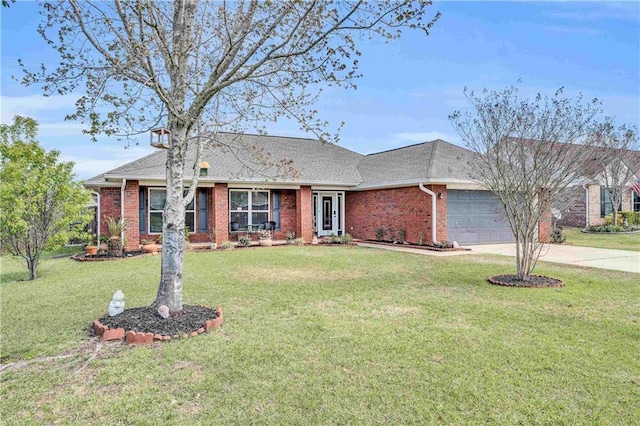 ranch-style home featuring a garage, a front lawn, brick siding, and driveway