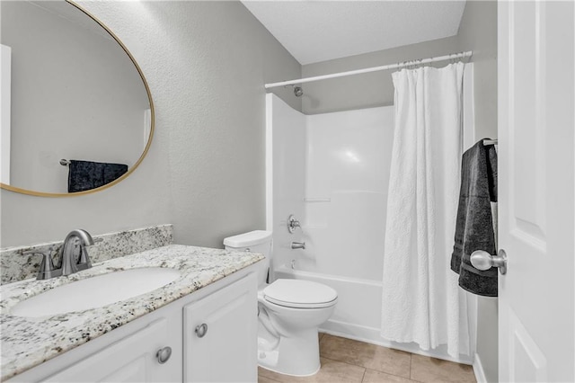 full bathroom with vanity, shower / bath combo, tile patterned floors, toilet, and a textured wall