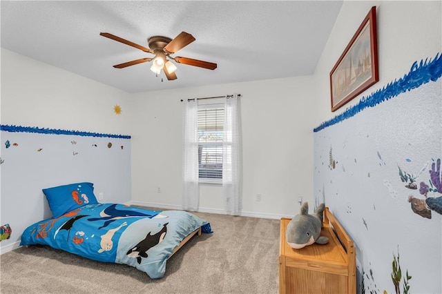 carpeted bedroom with baseboards, a textured ceiling, and a ceiling fan