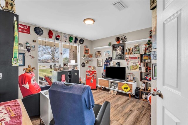 living room with visible vents and wood finished floors