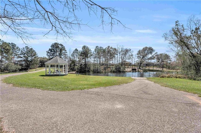 exterior space featuring a gazebo and a water view