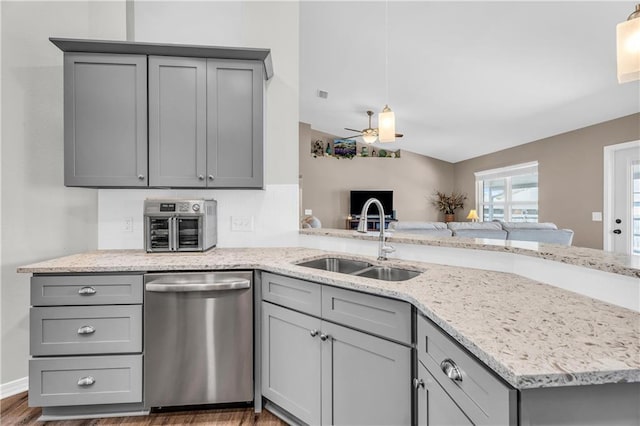 kitchen with light stone counters, a ceiling fan, a sink, gray cabinetry, and dishwasher