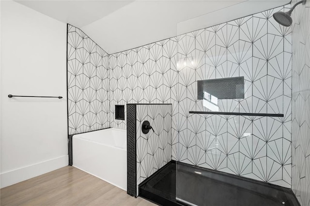 bathroom featuring hardwood / wood-style floors, lofted ceiling, and shower with separate bathtub