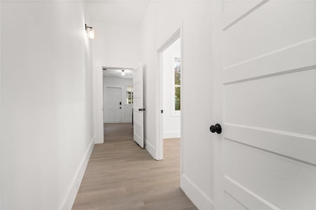 corridor with light hardwood / wood-style flooring