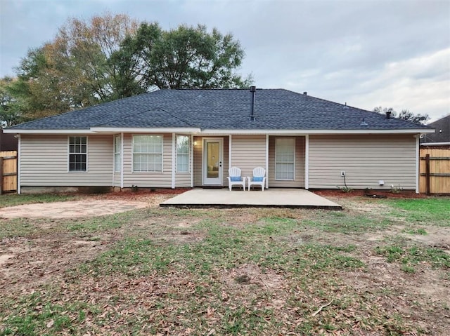 back of property with a patio