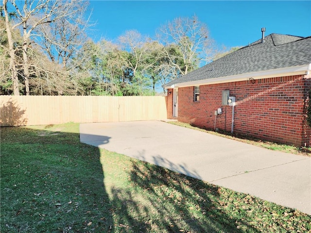 view of yard with fence and a patio