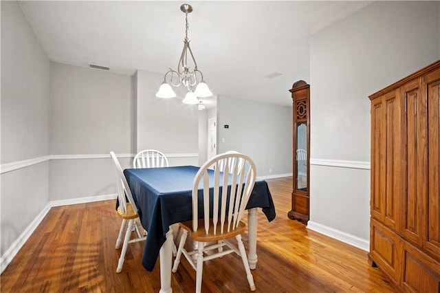 361 Tatum Ave, Mobile, AL 36609 - dining space featuring wood finished floors and a chandelier