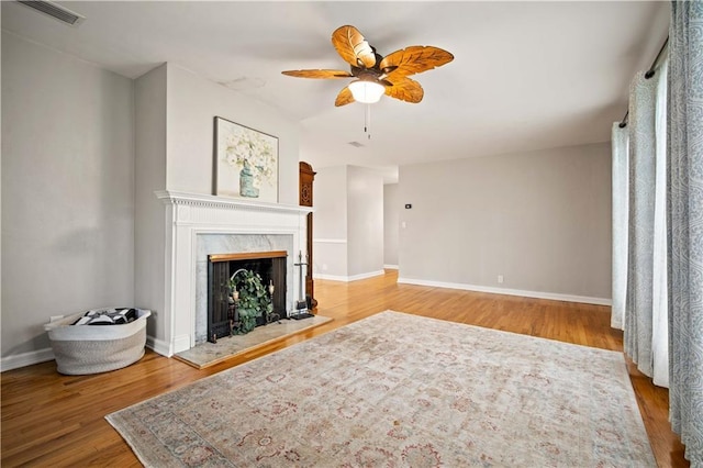 361 Tatum Ave, Mobile, AL 36609 - unfurnished living room featuring a high end fireplace, ceiling fan, and wood finished floors