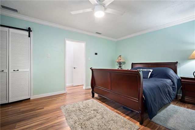 361 Tatum Ave, Mobile, AL 36609 - bedroom with crown molding, a barn door, wood finished floors, and ceiling fan
