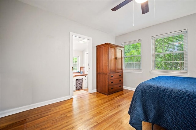 361 Tatum Ave, Mobile, AL 36609 - bedroom featuring light wood finished floors, multiple windows, a ceiling fan, and connected bathroom