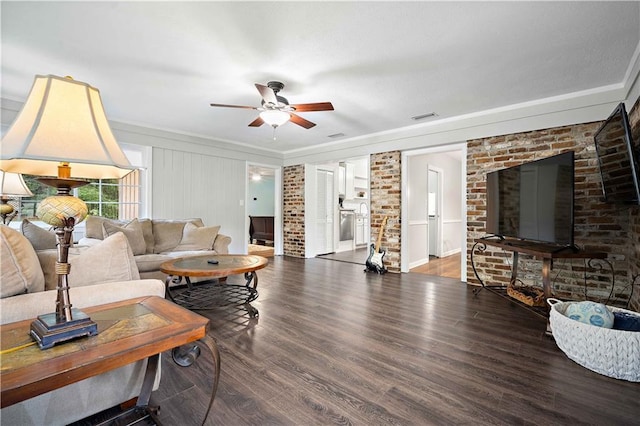 361 Tatum Ave, Mobile, AL 36609 - living room with ceiling fan, wood finished floors, crown molding, and brick wall