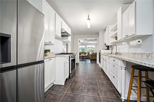 361 Tatum Ave, Mobile, AL 36609 - kitchen featuring stainless steel appliances, decorative backsplash, open shelves, and white cabinetry