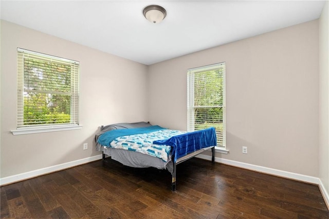 9100 Johnson Rd S, Mobile, AL 36695 - bedroom featuring multiple windows, wood-type flooring, and baseboards