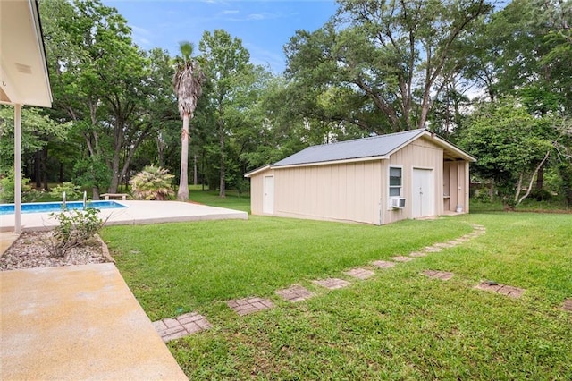 9100 Johnson Rd S, Mobile, AL 36695 - view of green lawn featuring an outdoor pool, an outbuilding, view of scattered trees, and a patio area