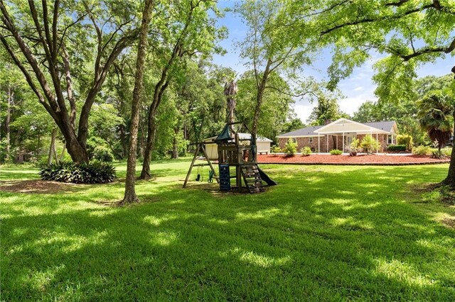 9100 Johnson Rd S, Mobile, AL 36695 - view of grassy yard featuring a playground