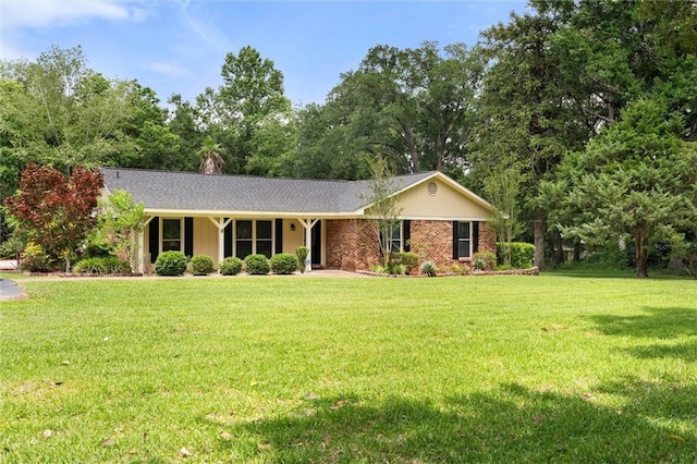 9100 Johnson Rd S, Mobile, AL 36695 - ranch-style home featuring a front lawn and view of wooded area