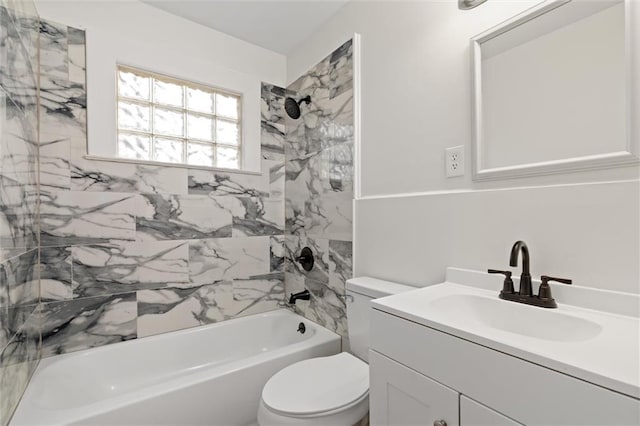 full bathroom featuring toilet, vanity, and tiled shower / bath