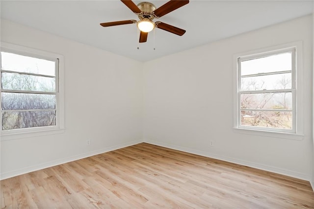 empty room featuring light hardwood / wood-style floors, plenty of natural light, and ceiling fan